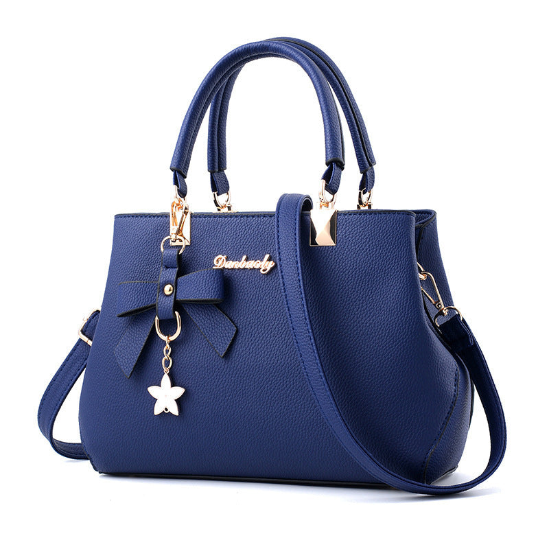 Bowtie top-handle crossbody satchel by Solenne, close-up of bow
