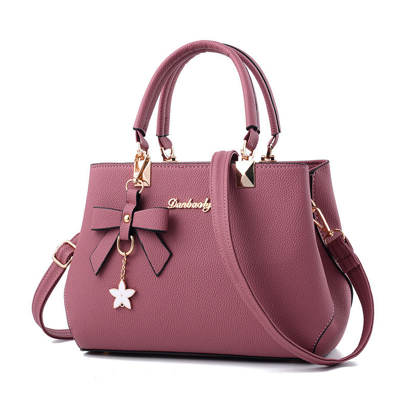 Bowtie top-handle crossbody satchel by Solenne, worn crossbody