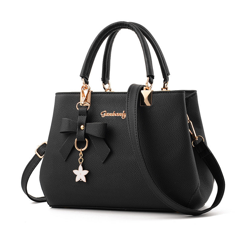 Bowtie top-handle crossbody satchel by Solenne, side view