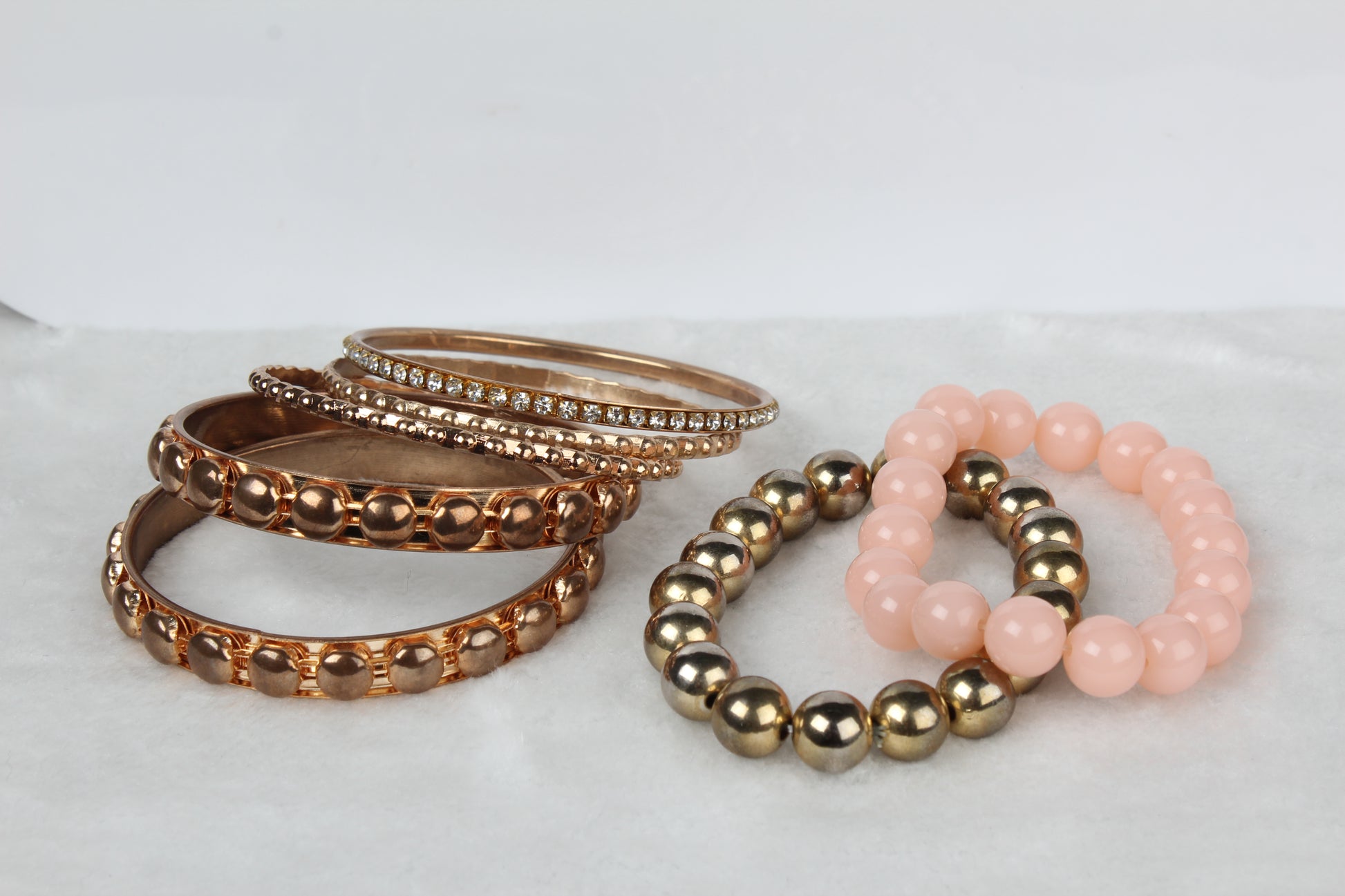 Gold stacked bangle bracelet set, 7-piece, by Solenne, in hand